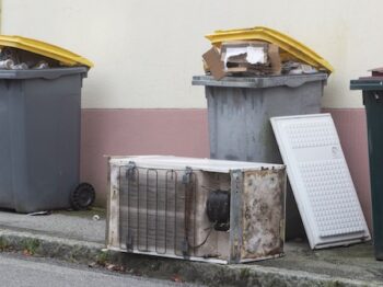 Garbage Bin And Left Behind Fridge In Brest