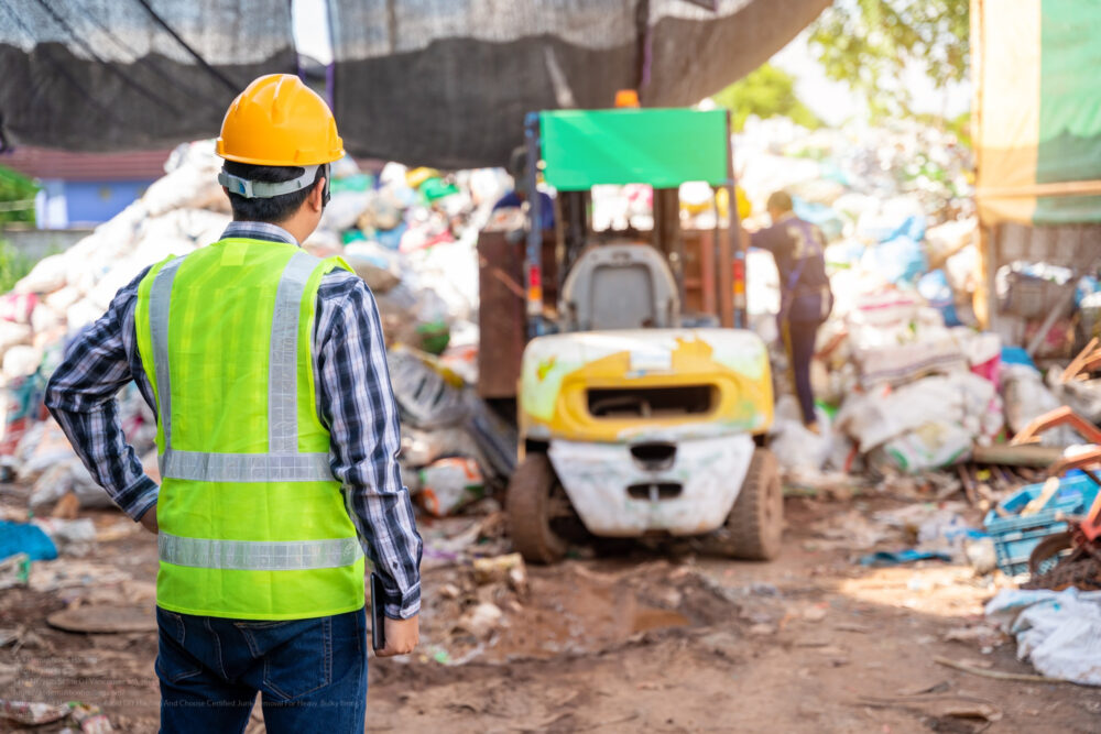 Asian Foreman Stand And Watch The Workers At Recycle Waste Facto